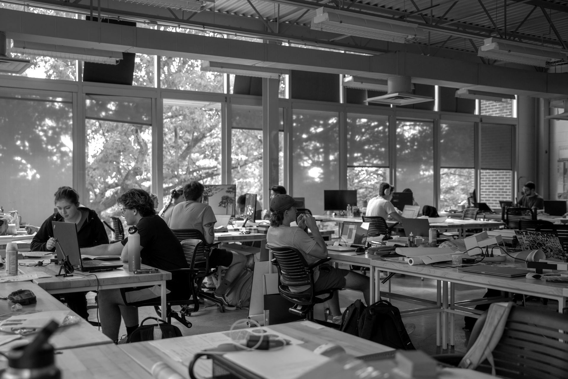 A black and white photo of a students sitting at desks in a classroom