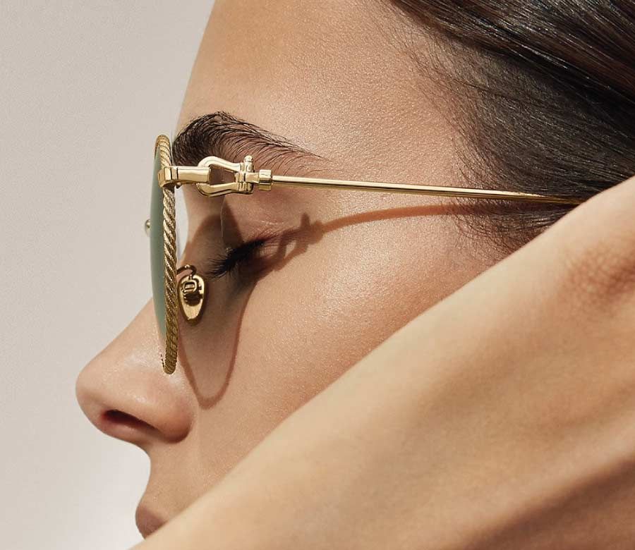 A close up of a woman 's face wearing sunglasses