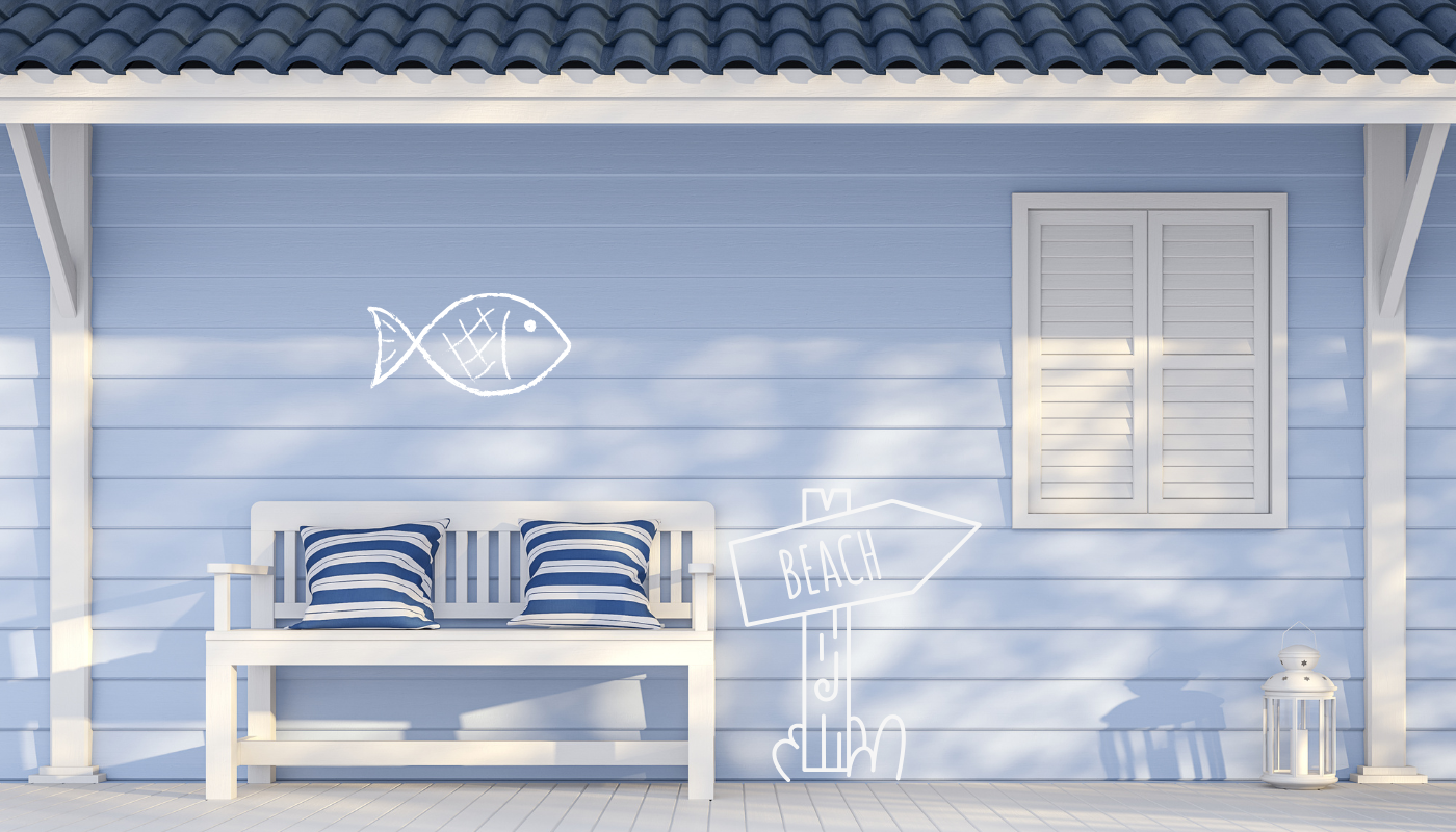 A blue house with a bench and a fish drawn on the wall.