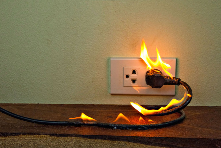 For Fire Damage Restoration, the image shows flames coming from an electrical outlet and electrical cord.