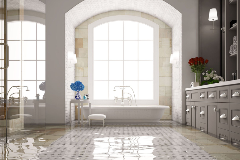 For Emergency Restoration, the image shows standing water covering floor tiles in a bathroom.