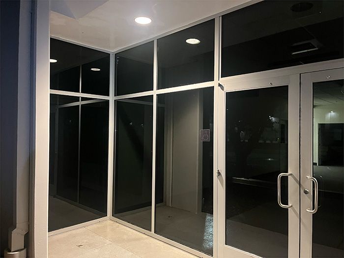 A building with a lot of glass doors and windows