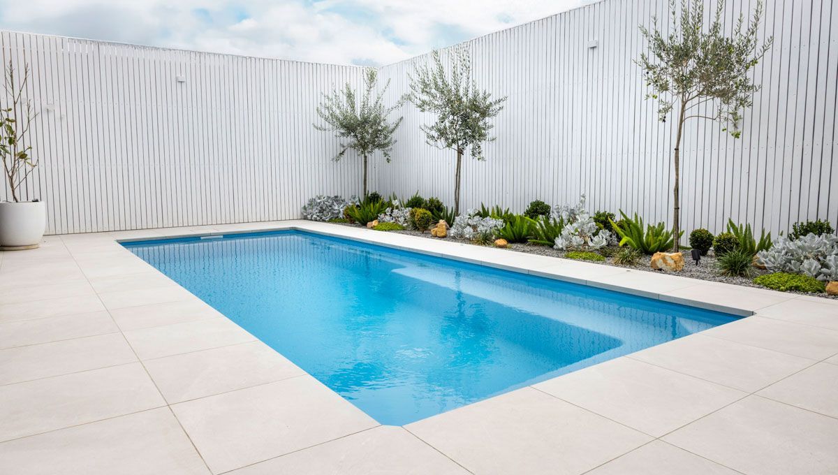 A Picture of a Medium Swimming Pool of a Billabong Slimline Sky Blue Shimmer 7.2m x 2.8m Mornington — SJ Pools and Concreting in Dubbo, NSW