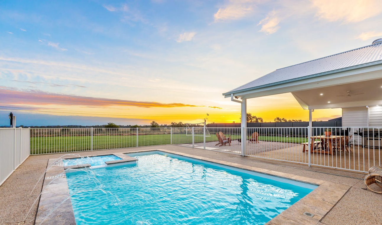 A pool is surrounded by a bright sunset looking out to a field — SJ Pools and Concreting in Bourke, NSW