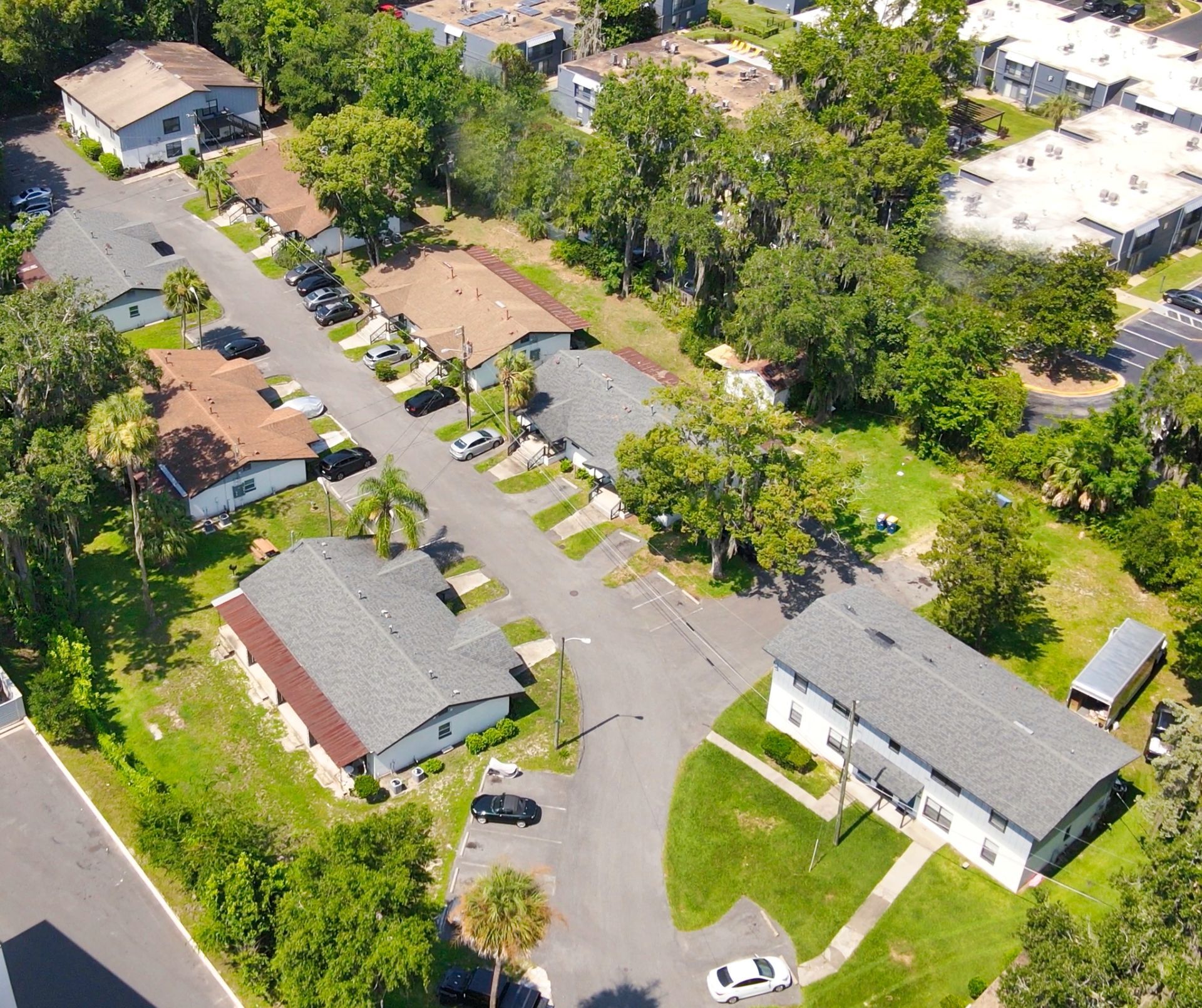 An aerial view of a residential area with apartment buildings and trees