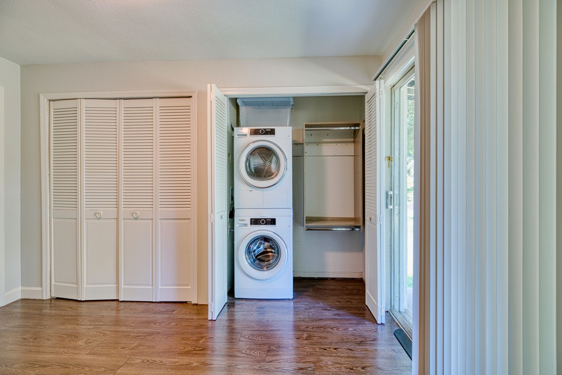 A laundry room with a washer and dryer stacked on top of each other.