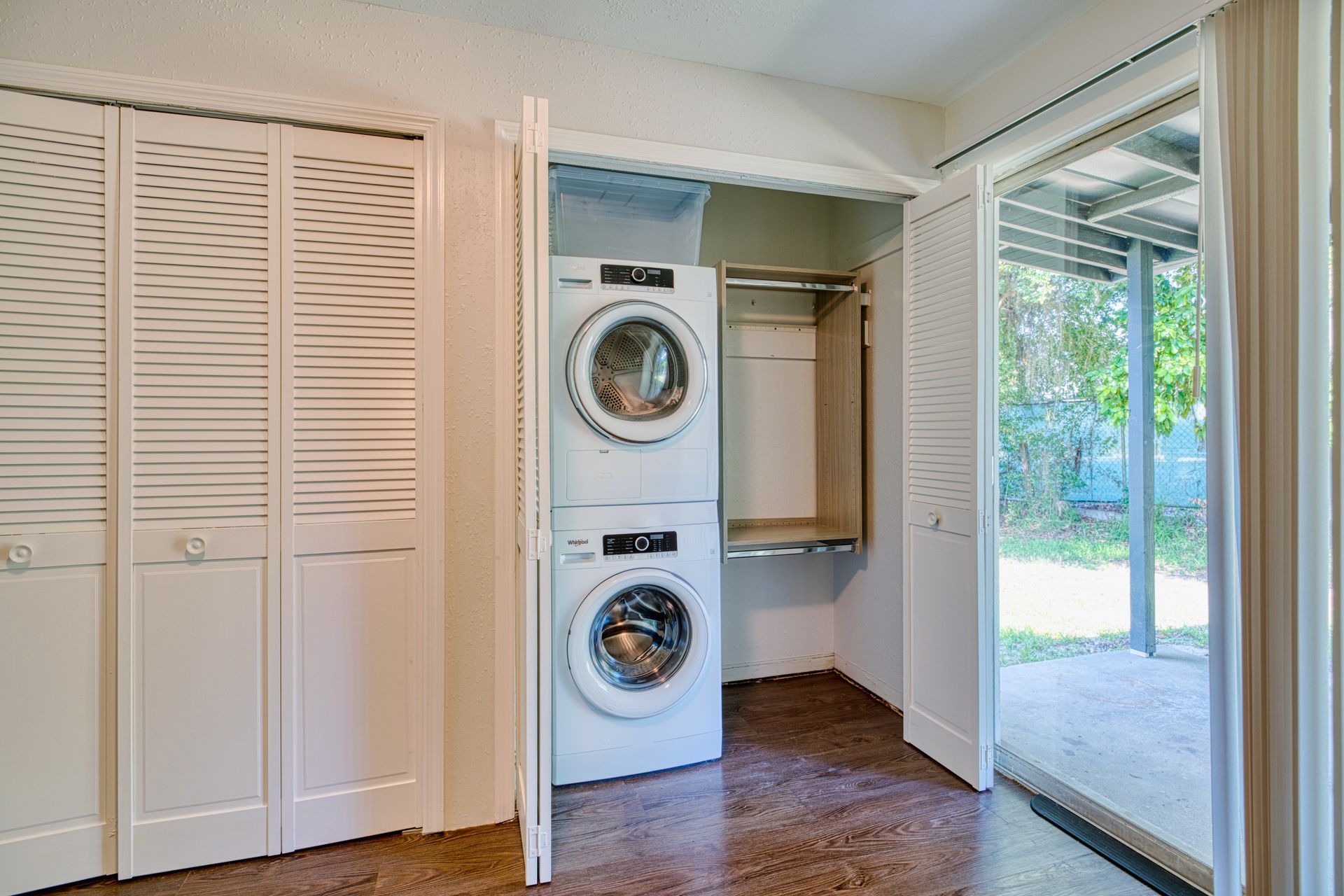 A laundry room with a washer and dryer stacked on top of each other.