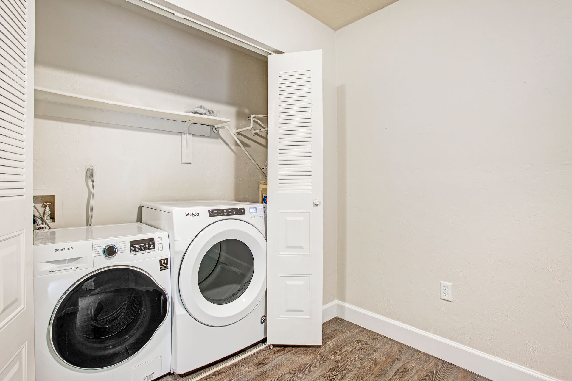 A laundry room with a washer and dryer in a closet.