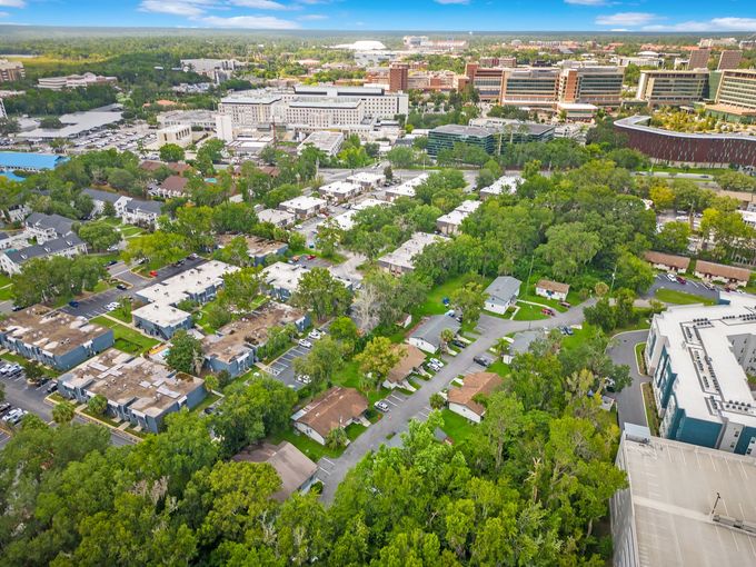 An aerial view of a residential area surrounded by trees and buildings.