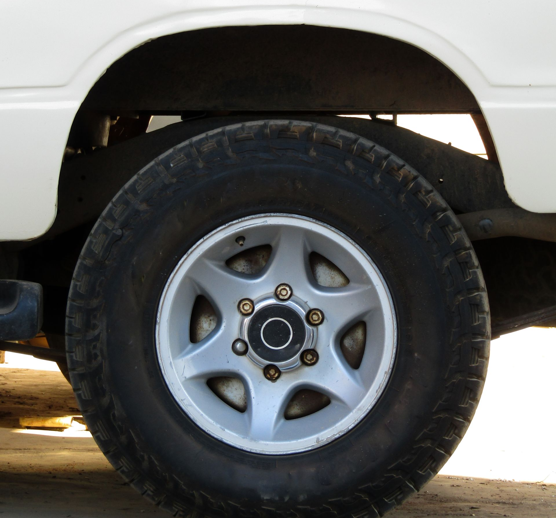 Closeup of Car Jack Lifting Car Tire