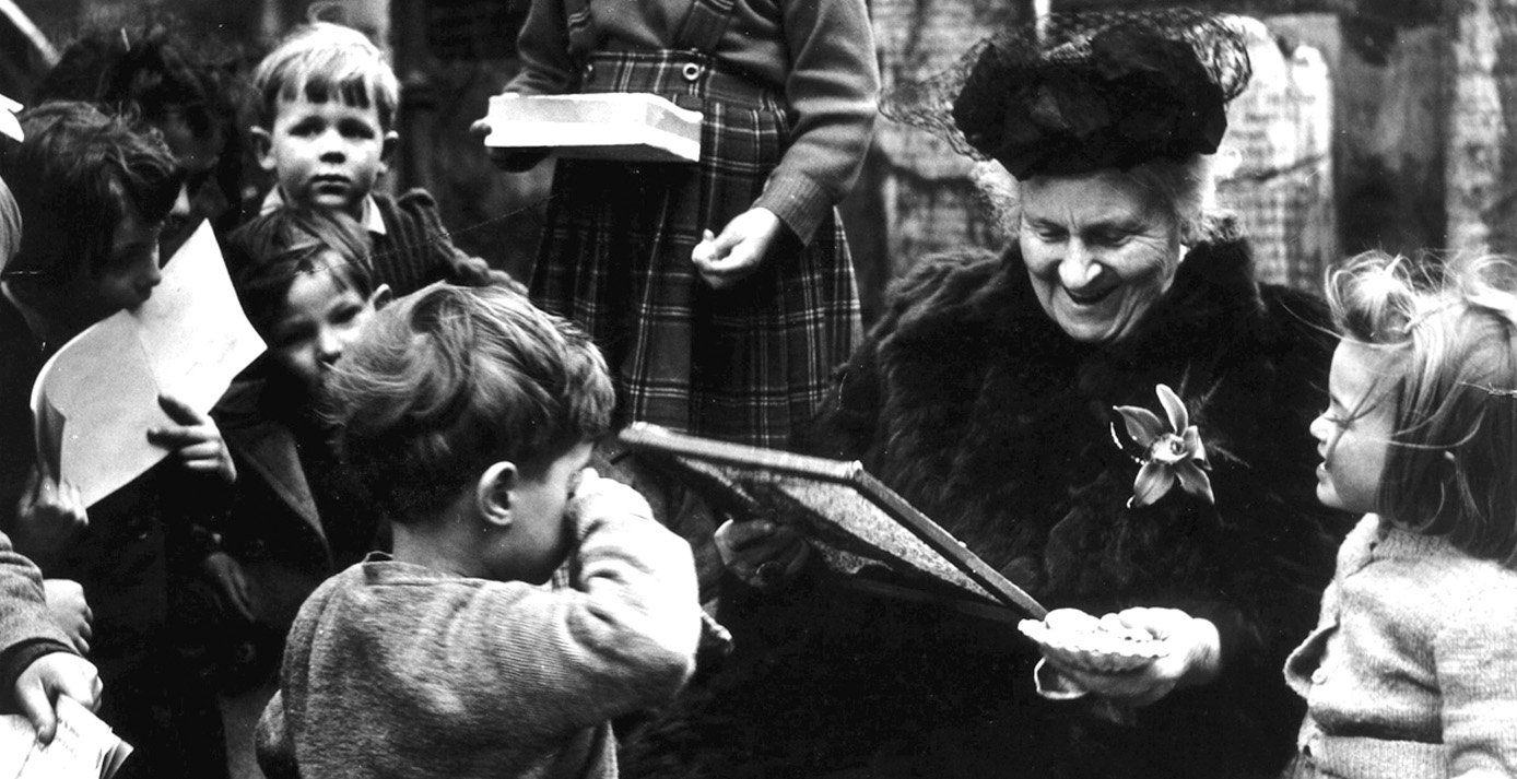 Dr. Maria Montessori surrounded by children