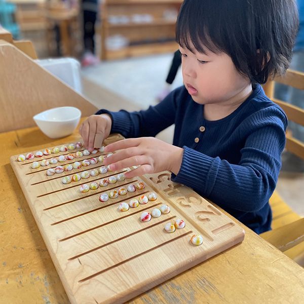 Montessori child working with math activity