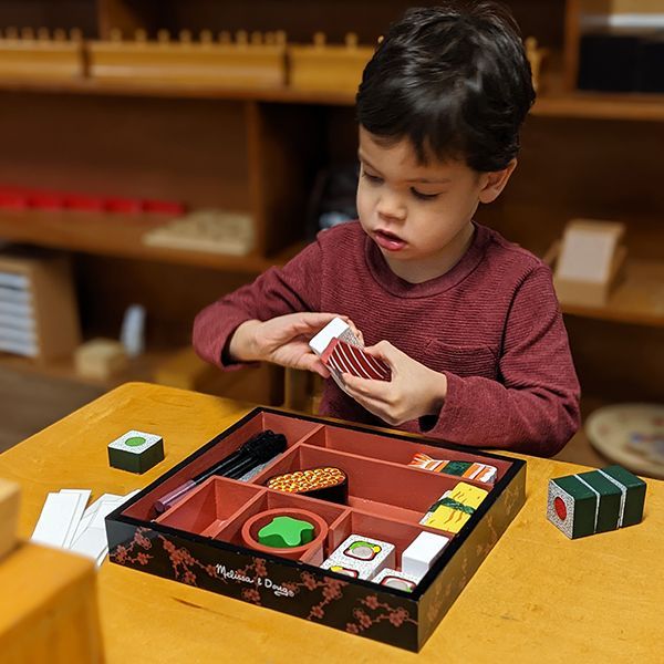 montessori child working with practical life skills activity