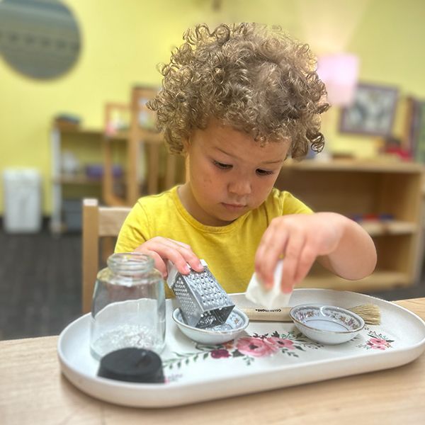 Montessori child working with soap grating