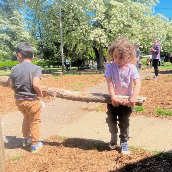 montessori children helping each other outside activity