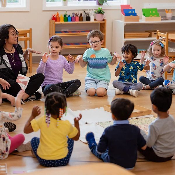 montessori children with guide inside the classroom