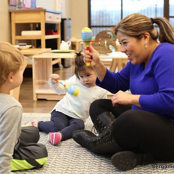 Guide and children in a Montessori classroom