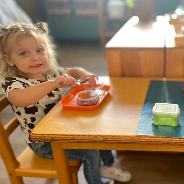 Montessori children working with practical life activity