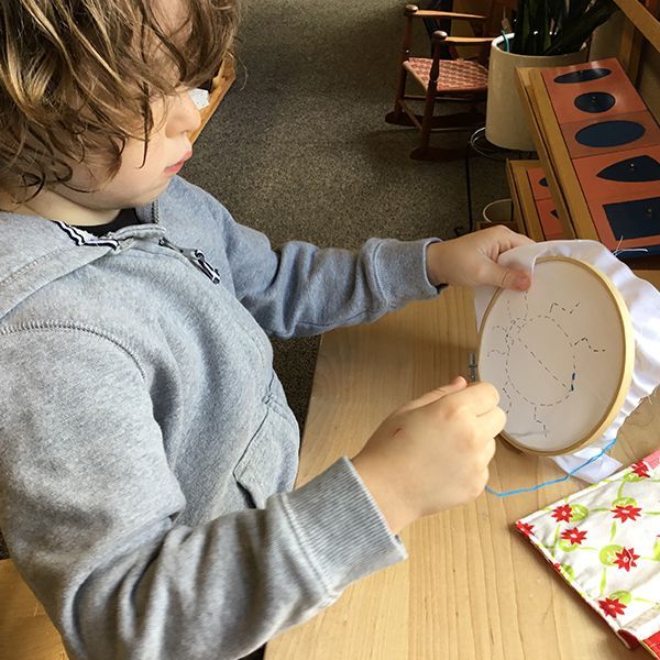 Child working with a Montessori language material