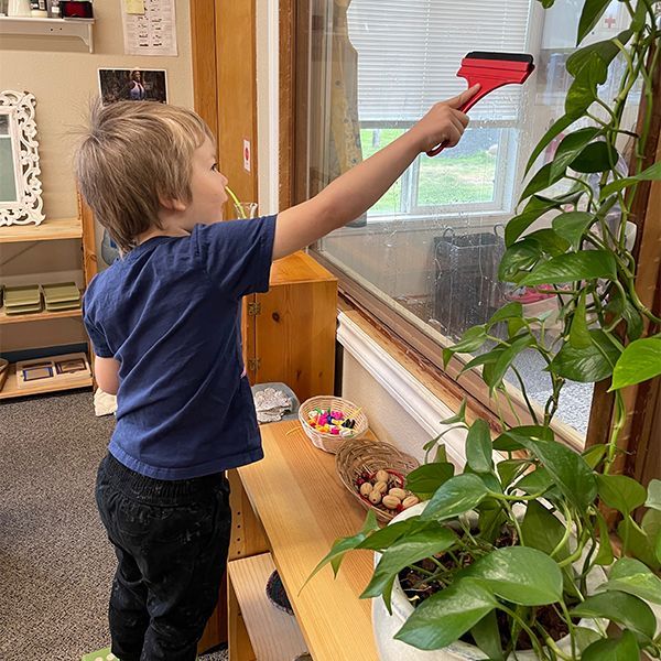 Child working with Montessori knobbed cylinders