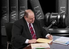 Attorney Kenneth M. Alpert Signing a Document — Criminal Defense Attorneys in Park Ridge, IL