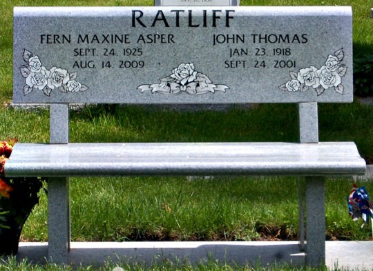 Gray granite bench-style headstone with 