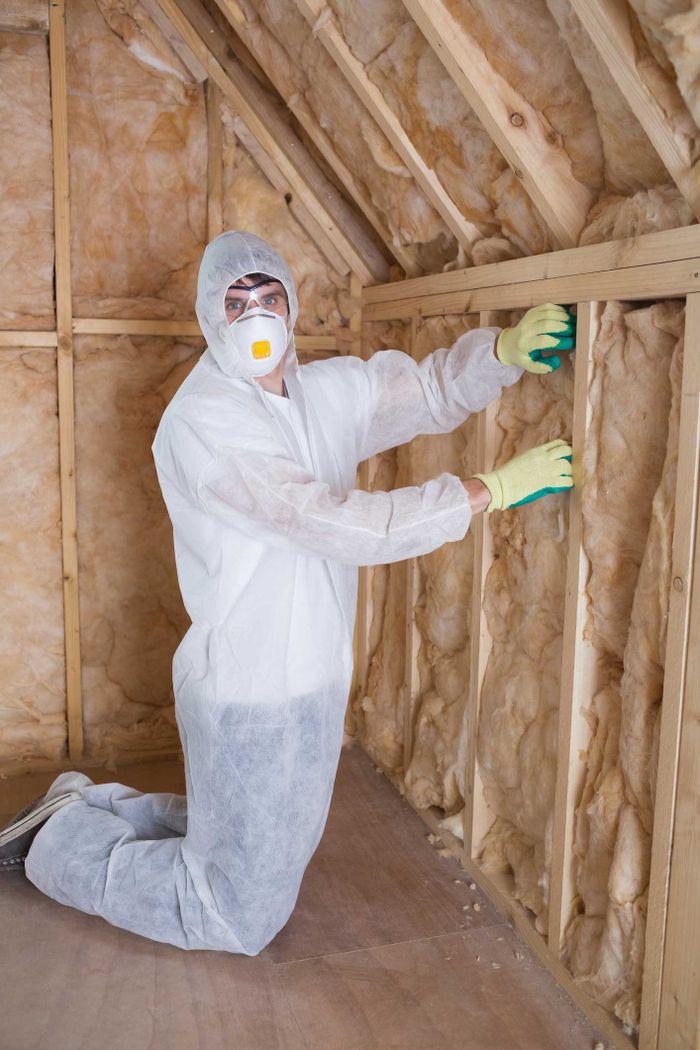 Man Filling Walls With Insulation — Jacksonville, FL — North Florida Insulation
