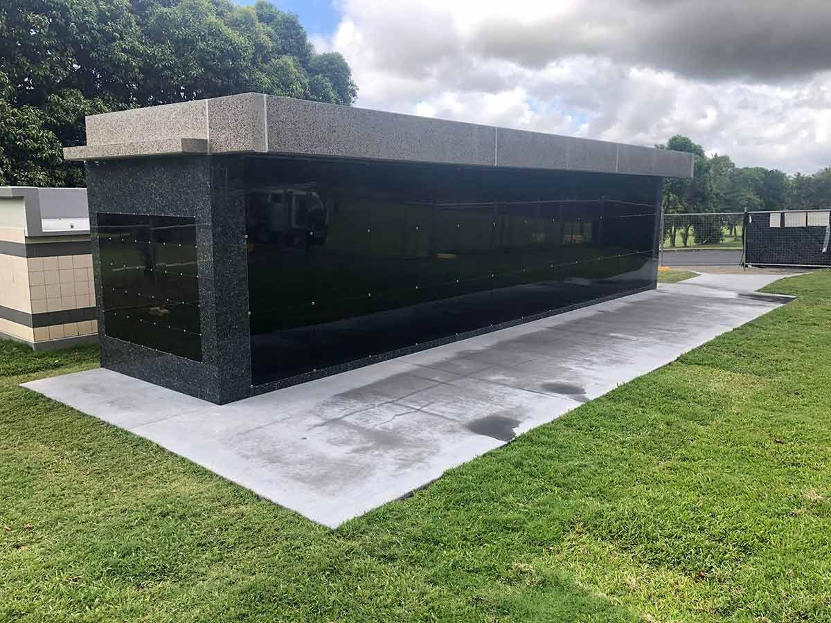 A Large Building Is Sitting On Top Of A Lush Green Field — Gori Marble & Granite Pty Ltd in Earlville, QLD
