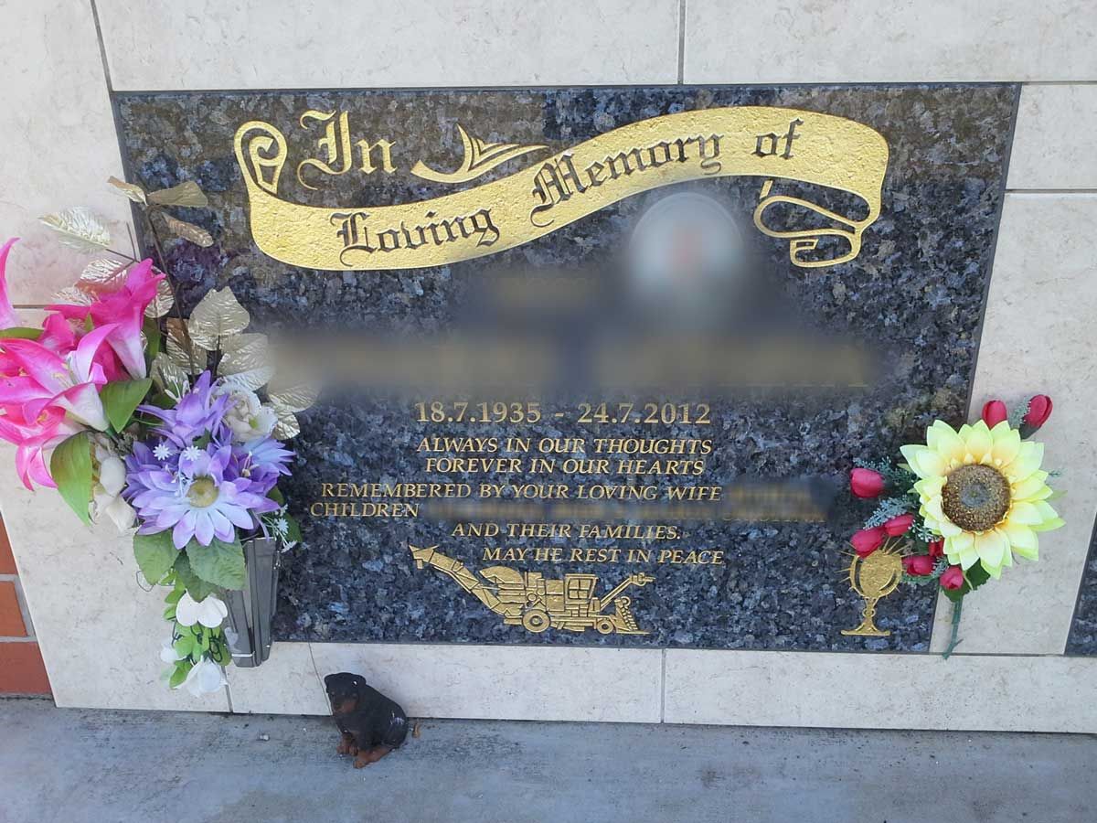 A Gravestone With Flowers On It — Gori Marble & Granite Pty Ltd in Earlville, QLD