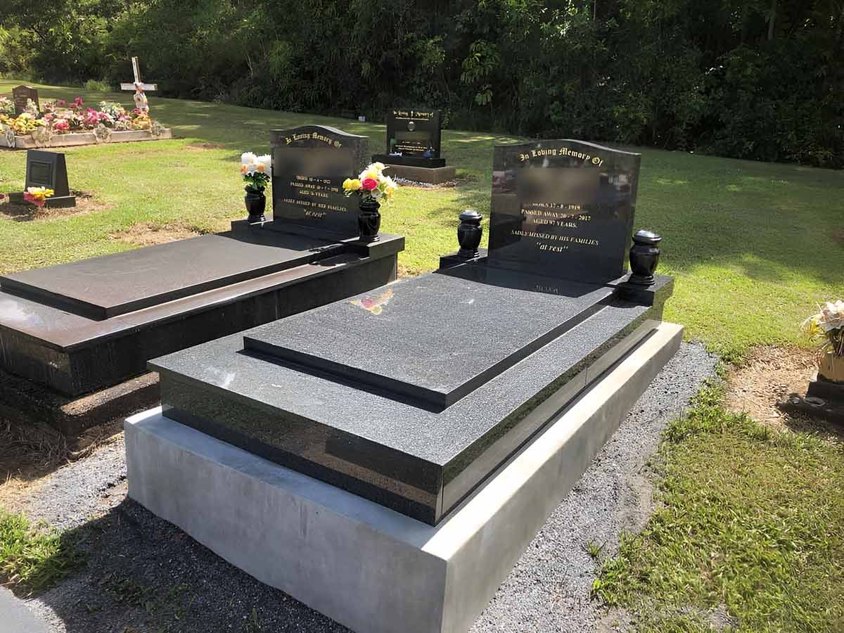 A Couple Of Graves In A Cemetery With Flowers On Them — Gori Marble & Granite Pty Ltd in Earlville, QLD