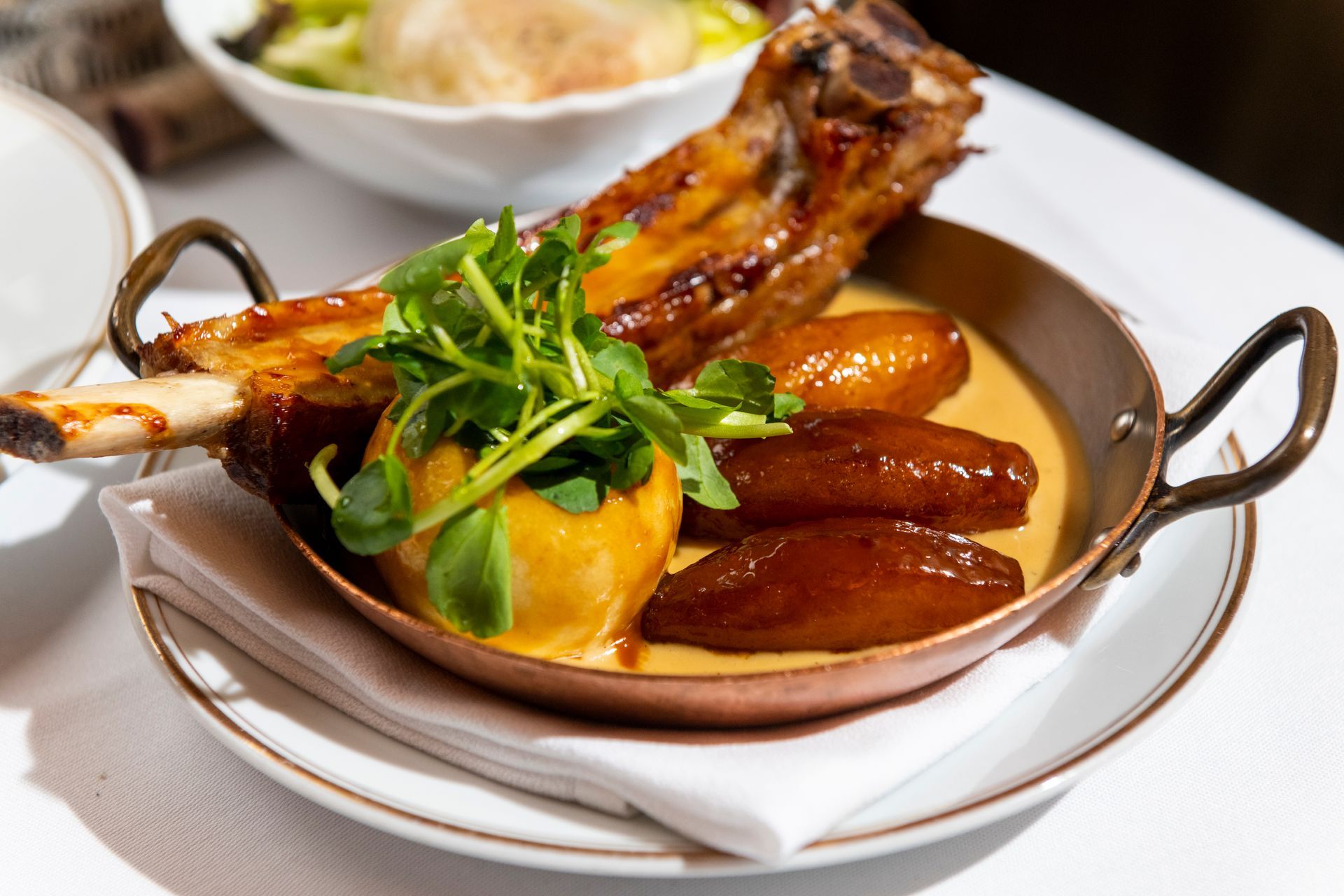 A plate of food with meat and vegetables on a table.