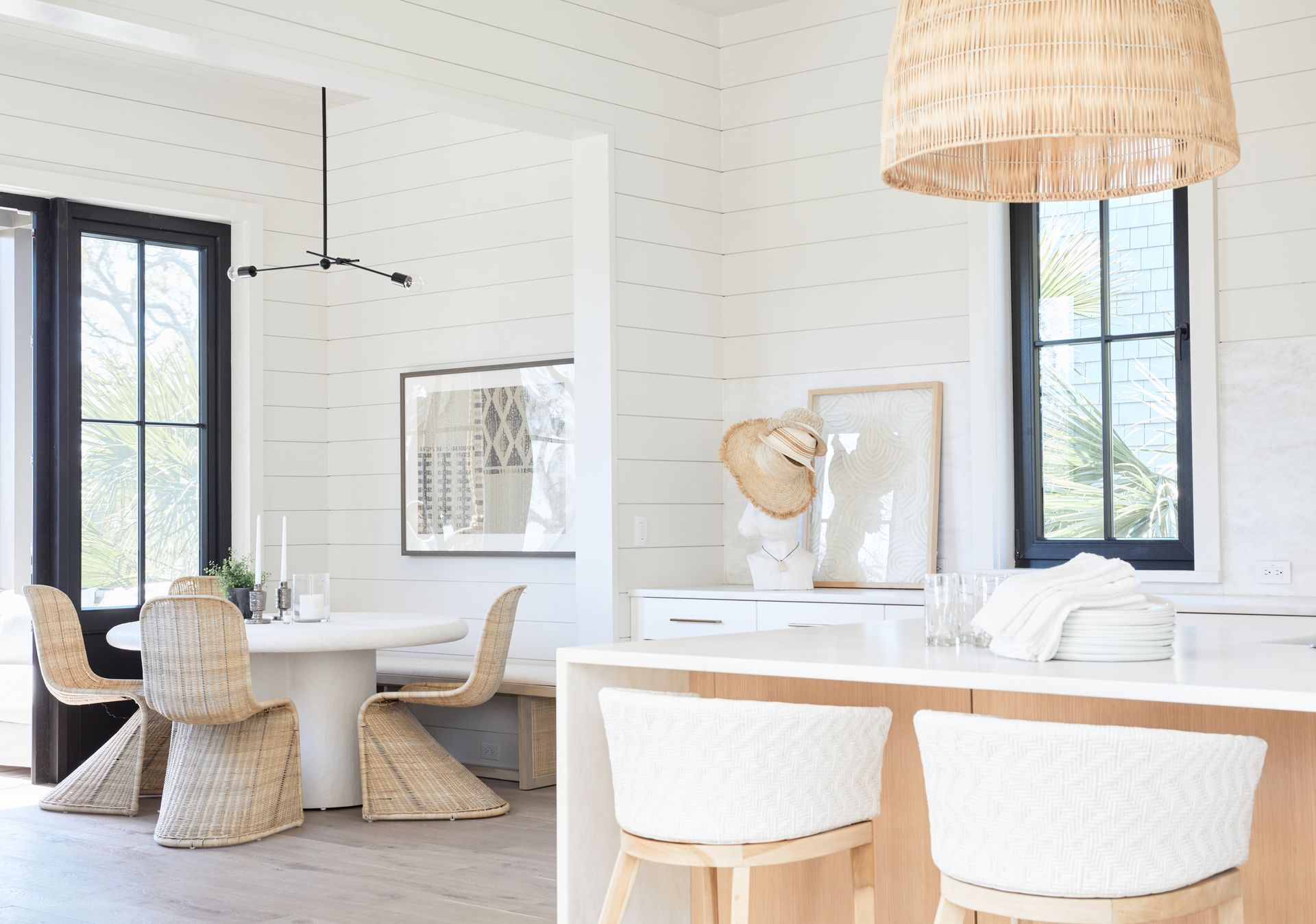 A kitchen with a table and chairs and a bar.