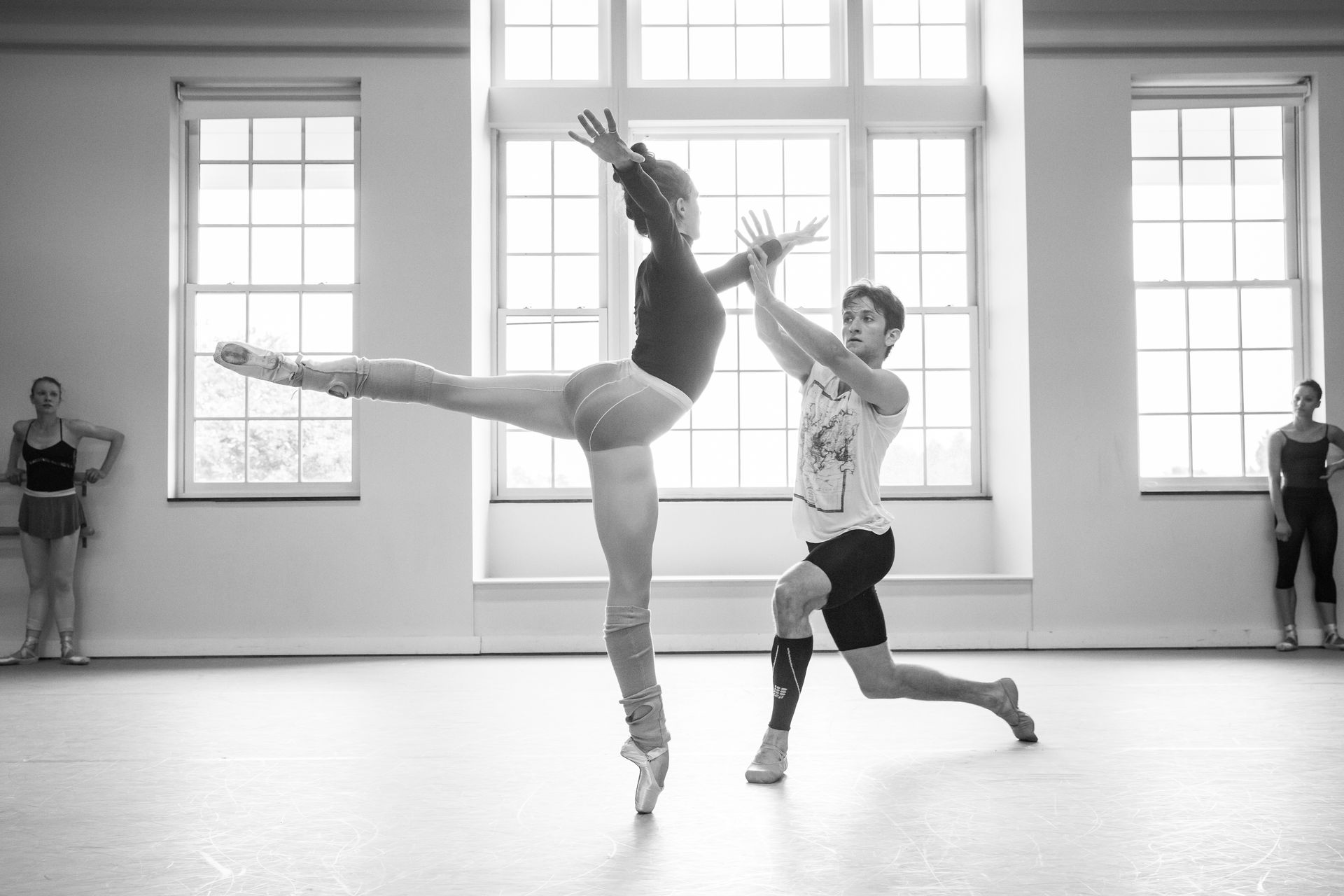 A man and a woman are dancing in a dance studio.