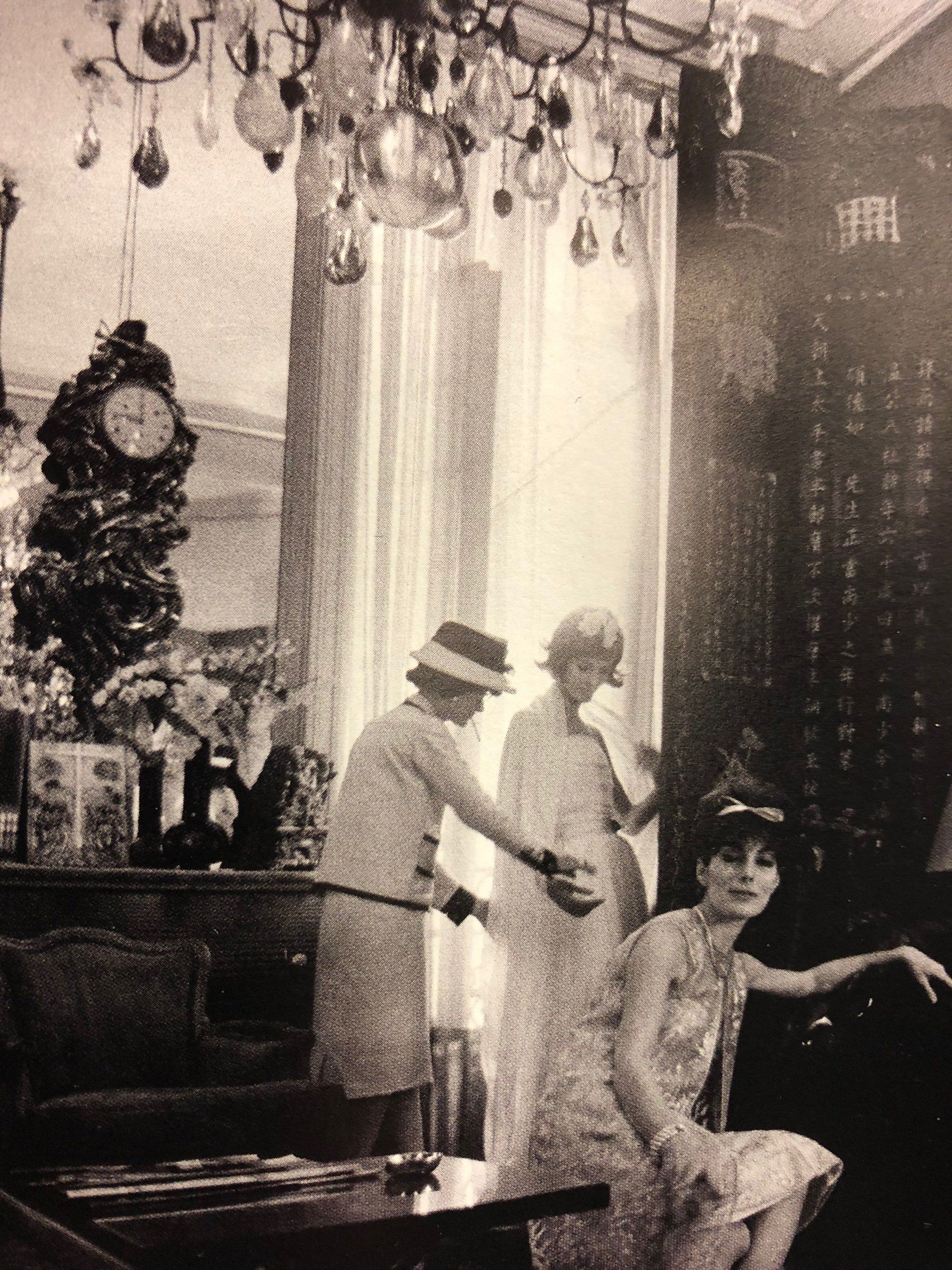 A black and white photo of three women in a room