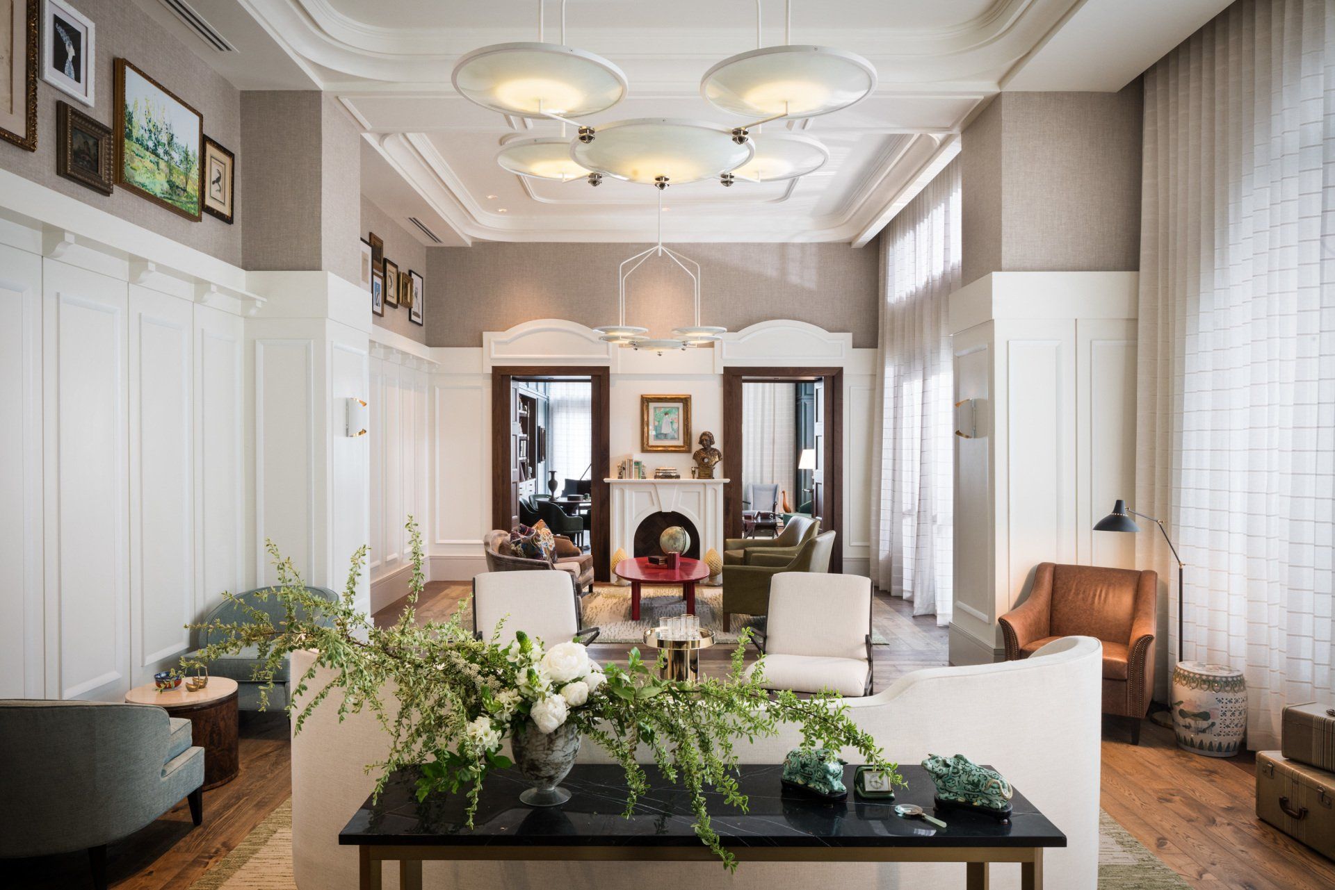 A living room filled with furniture and a table with flowers on it.