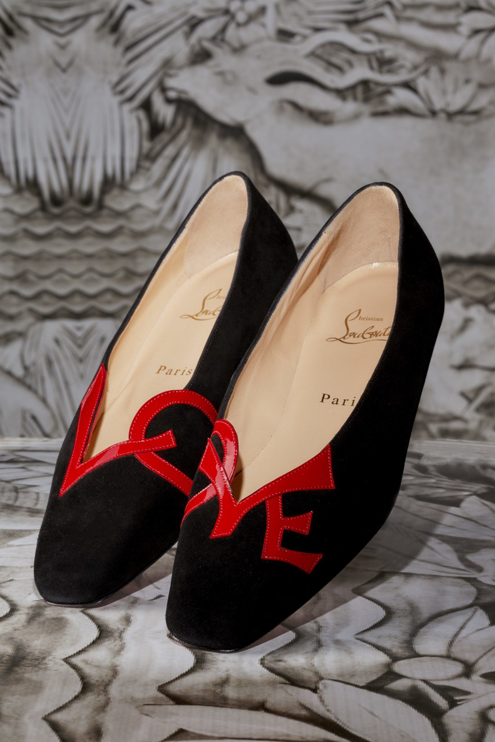 A pair of black shoes with the word love on them