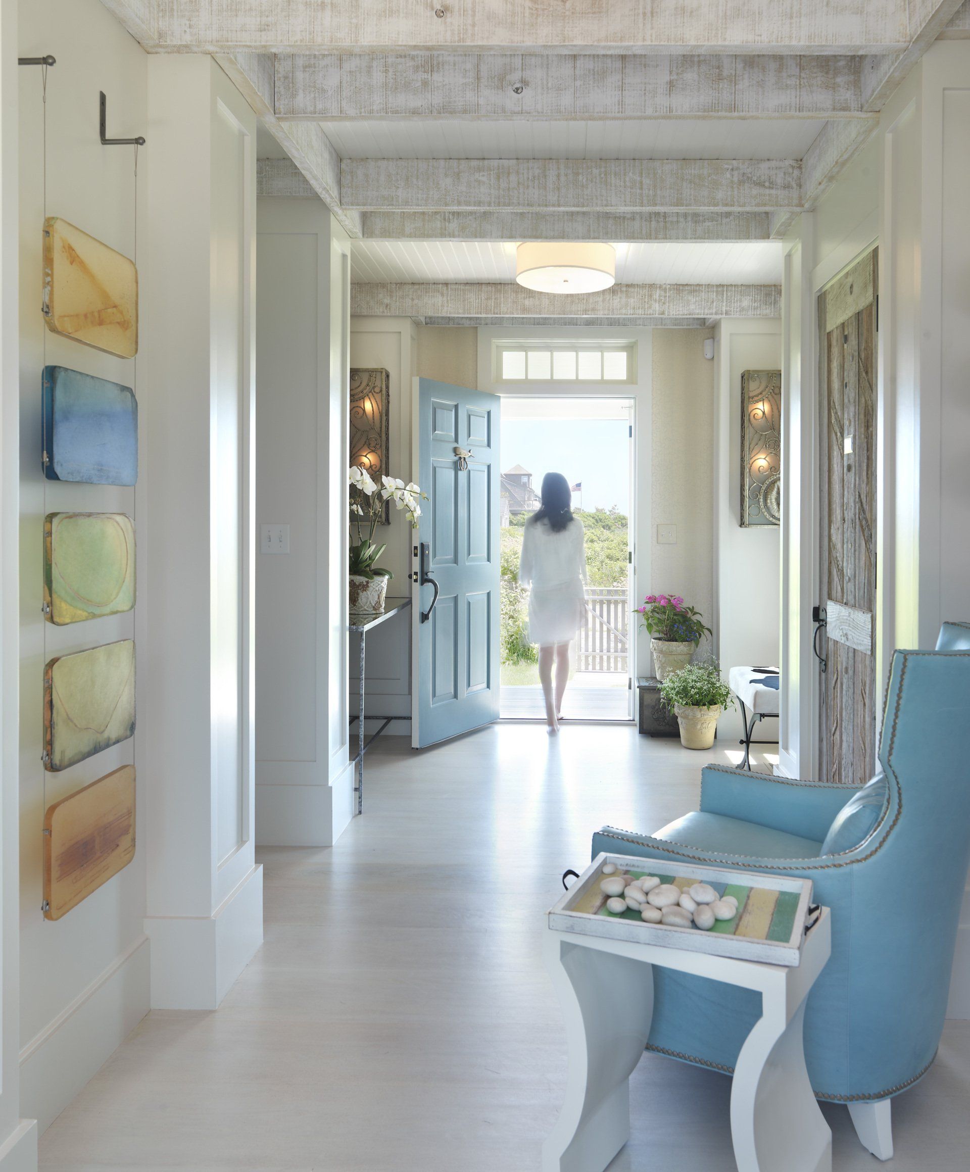 A woman in a white dress is walking through a hallway