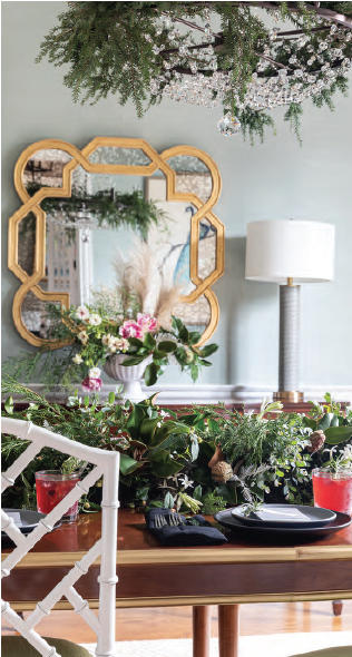 A dining room with a table and chairs and a mirror.