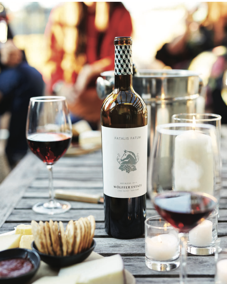 A bottle of wine sits on a wooden table