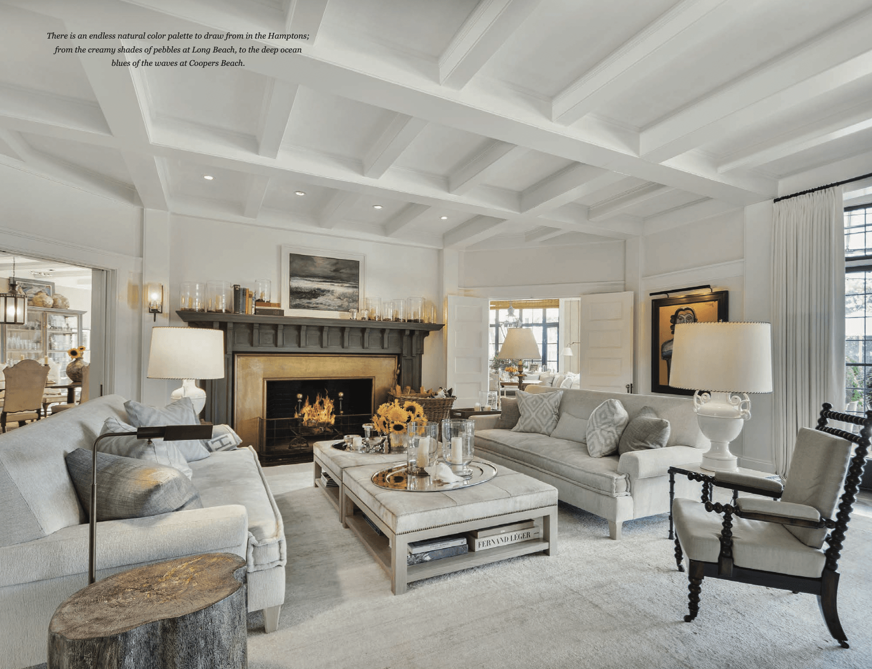 A living room with white furniture and a fireplace