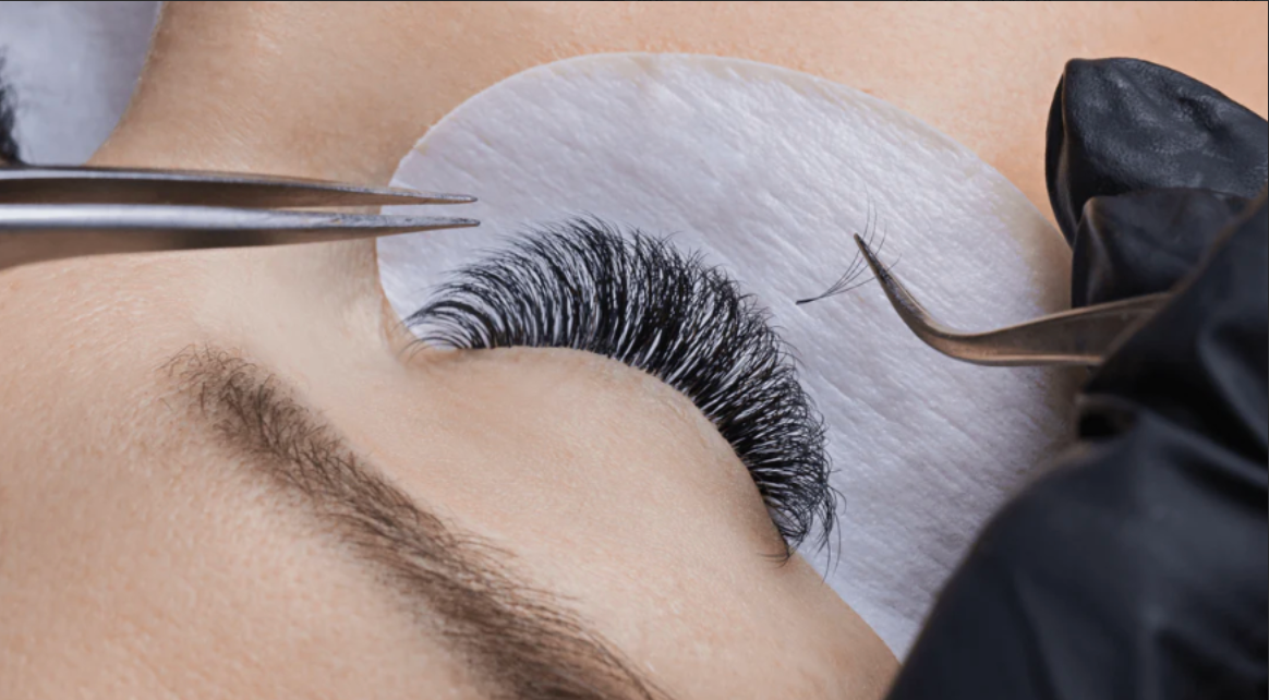 A close up of a woman getting eyelash extensions.