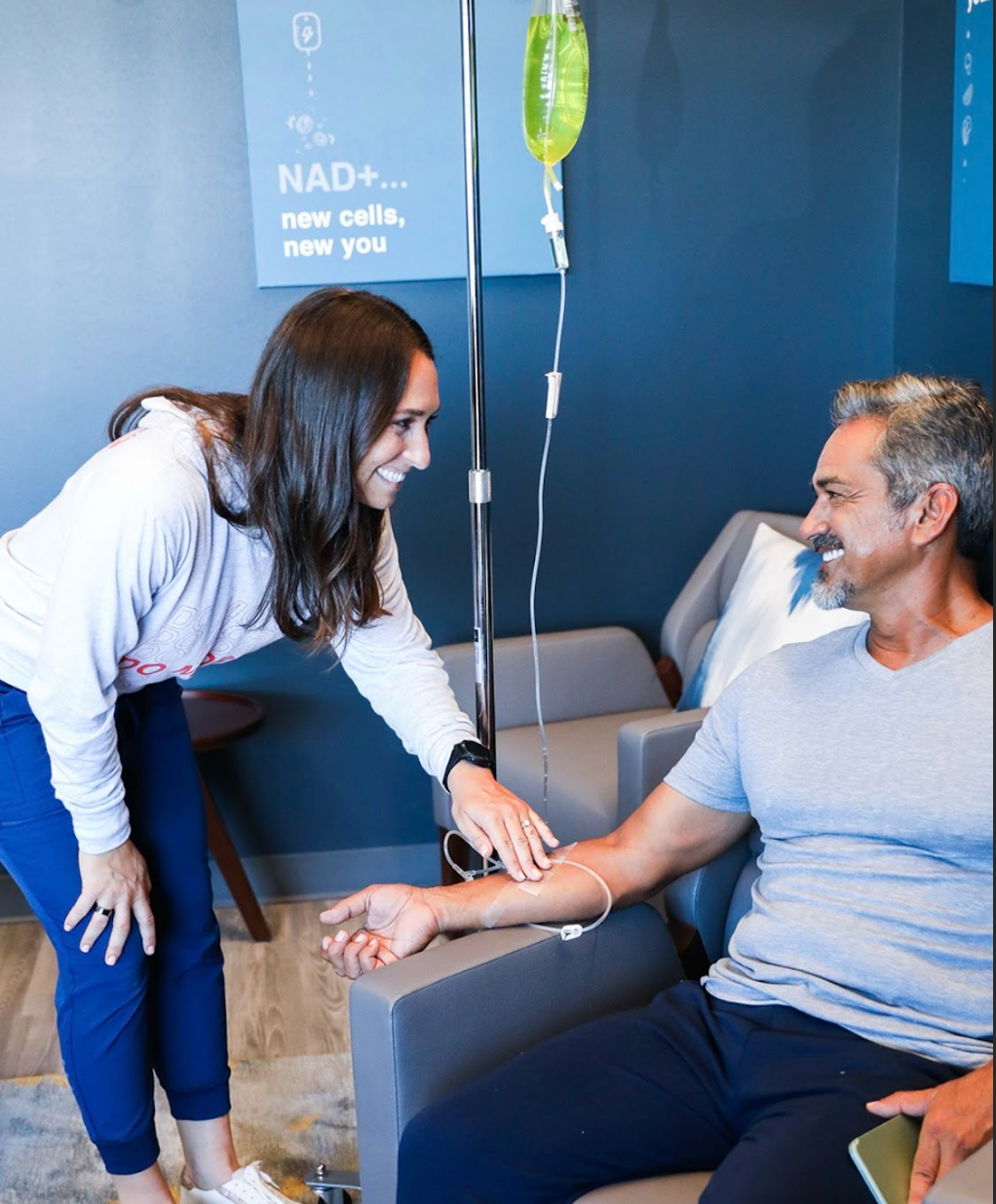 Man Getting an IV Drip from Woman Practitioner 