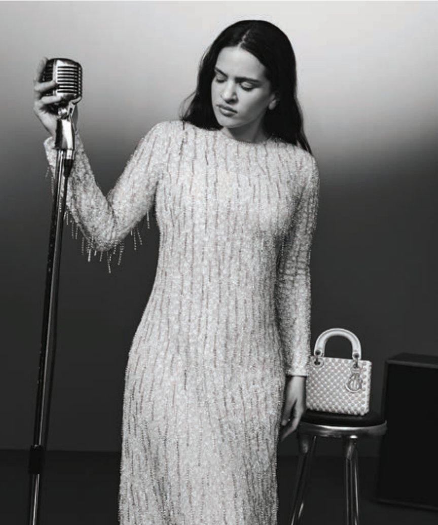 A woman in a dress is singing into a microphone