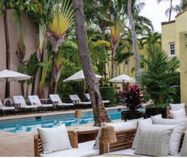 A swimming pool with chairs and umbrellas around it