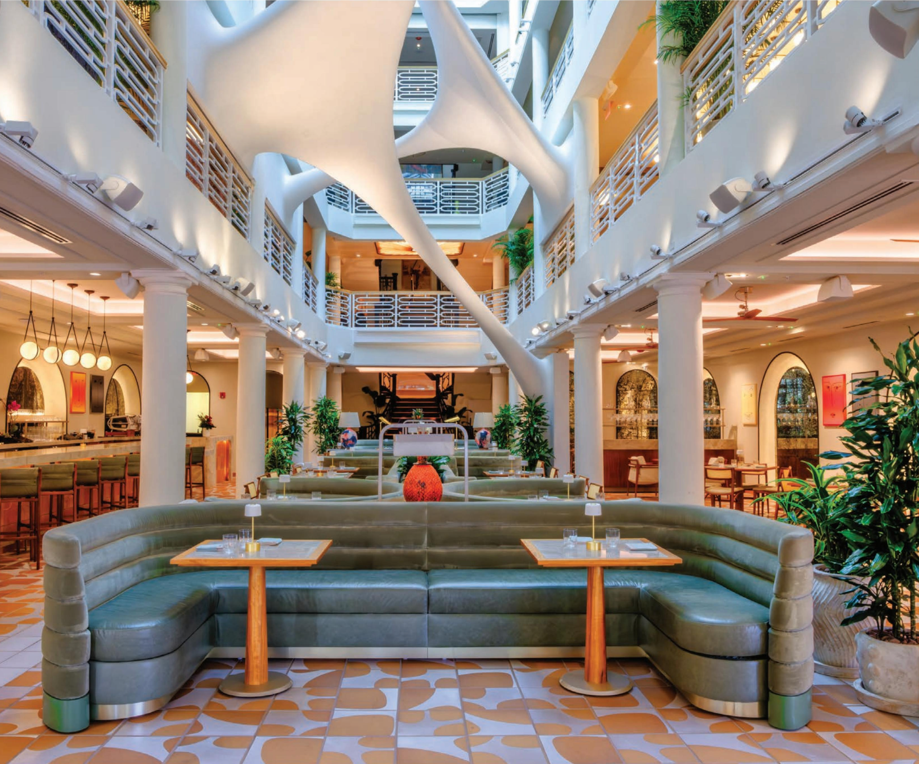 A large room with a couch and tables in it