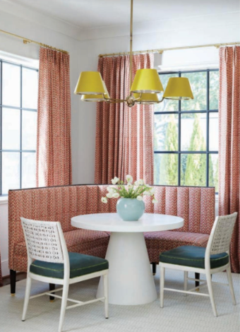 A dining room with a table and chairs and a window