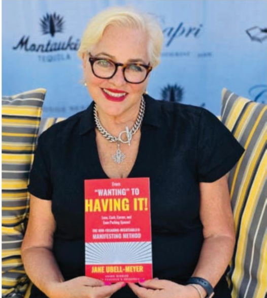 A woman is holding a book titled 