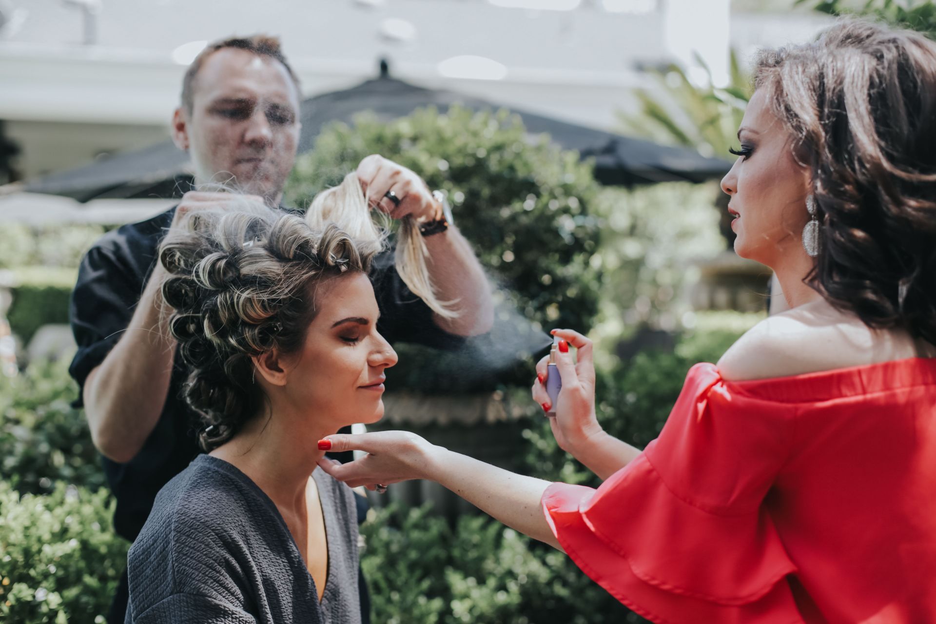 A woman is getting her hair done by a hairdresser.