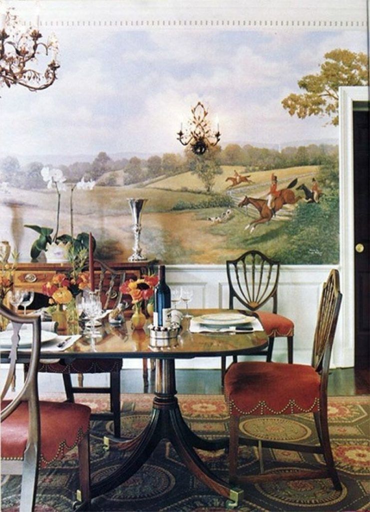 A dining room with a table and chairs and a painting on the wall