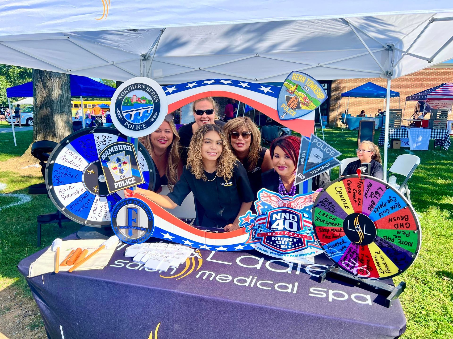 A group of people are posing for a picture in front of a tent.